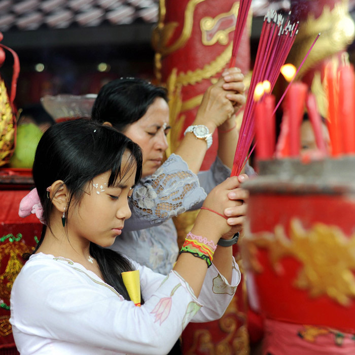 Woman pray at a Buddhist temple in Denpasar